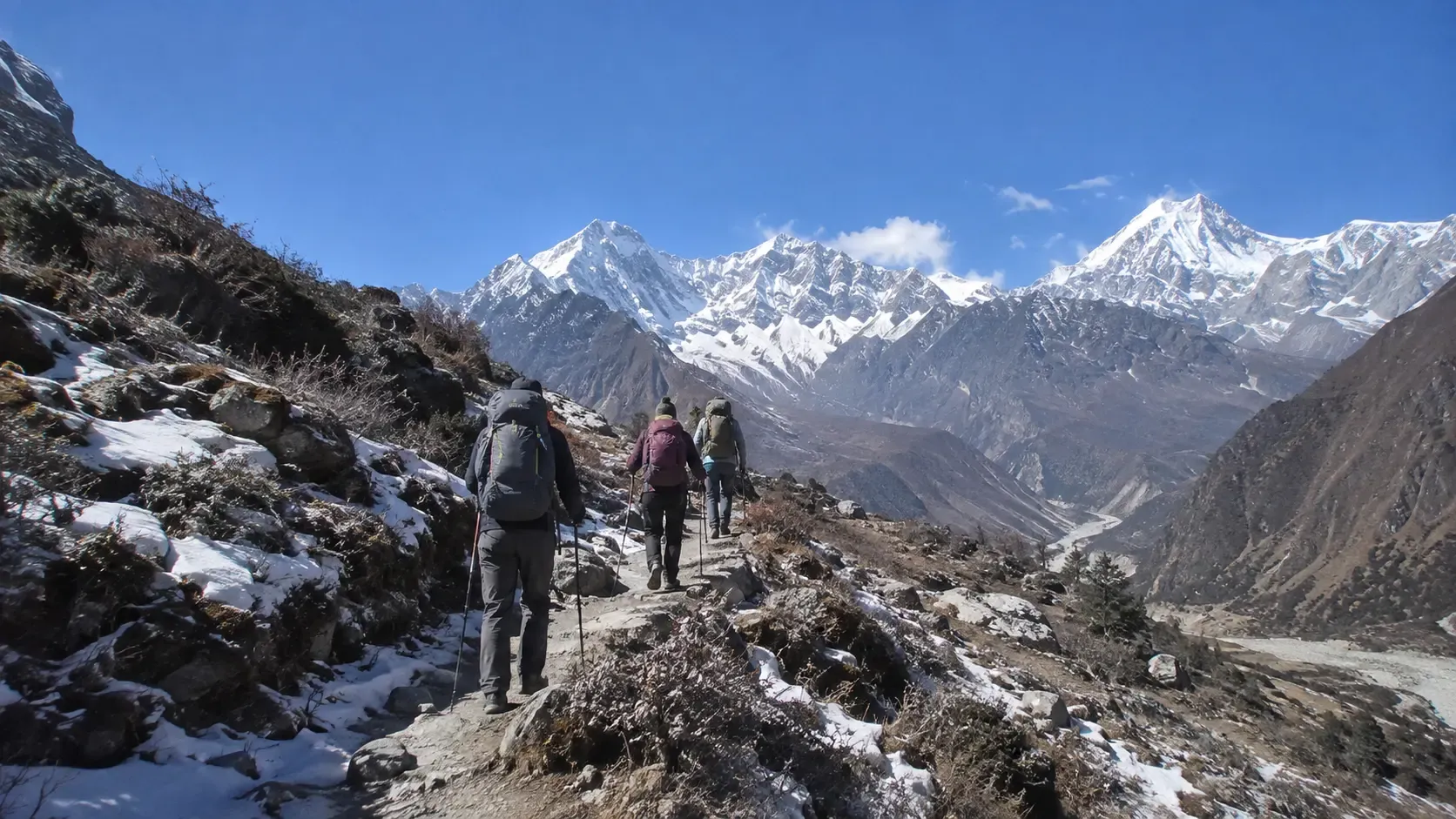 Trekker walking on a snowy Himalayan trail in Nepal during winter